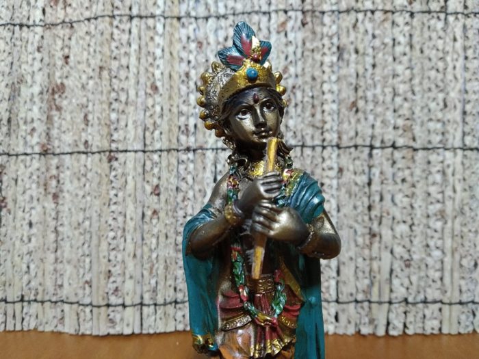 Estátua indiana de Krishna tocando flauta em resina pintada