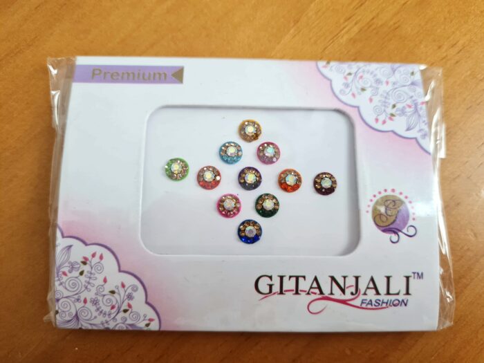 Bindi para colar na testa entre as sombrancelhas, no local do terceiro olho. Ideal para usar em festas indianas, temáticas. Cartela de adesivos. 11 Bolinhas coloridas
