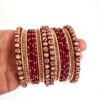 Conjunto de pulseiras indianas 24 peças douradas e vermelhas Ishani