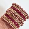 Conjunto de pulseiras indianas 24 peças douradas e vermelhas Ishani